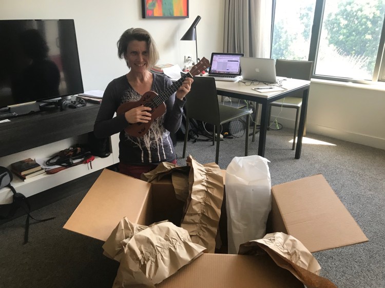 woman unpacking ukulele